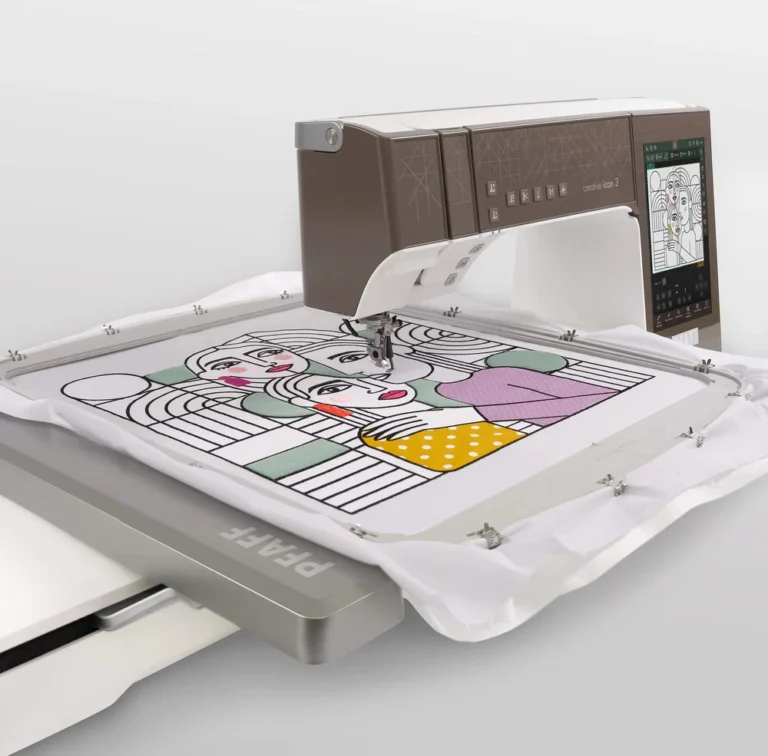 A computerized embroidery machine, the Pfaff Icon 3 Sewing Machine, is stitching a colorful abstract portrait of three people onto white fabric held in a frame.